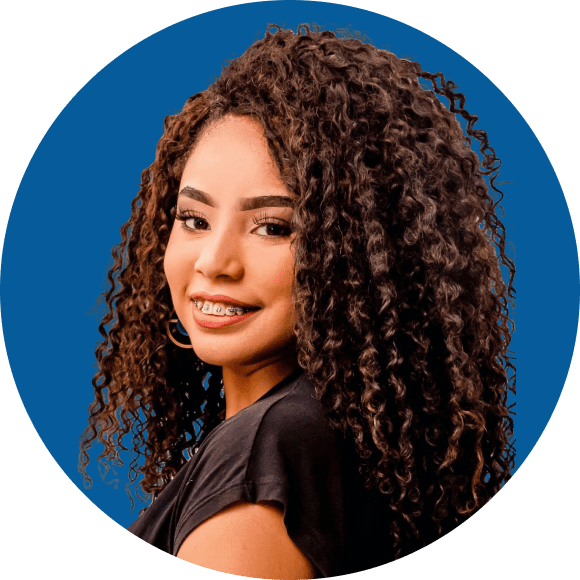 Smiling young woman with braces and long curly hair, black top, blue circle backdrop at Queen City Orthodontics in Liberty Township or Hamilton, OH.